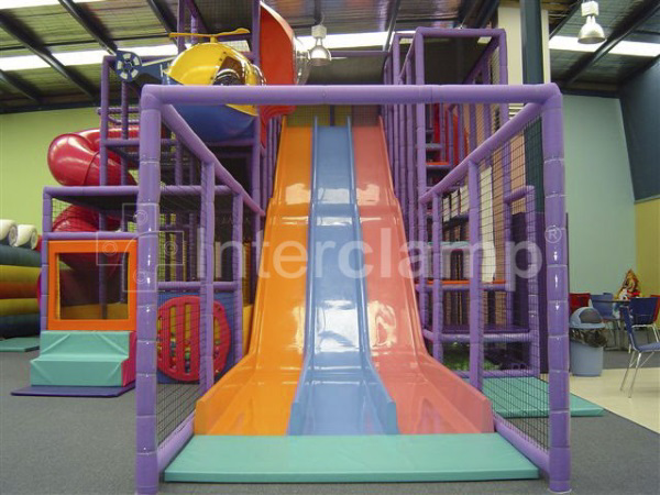 A vibrant indoor play structure built with Interclamp tube clamp fittings, demonstrating their application in creating safe and engaging play areas.